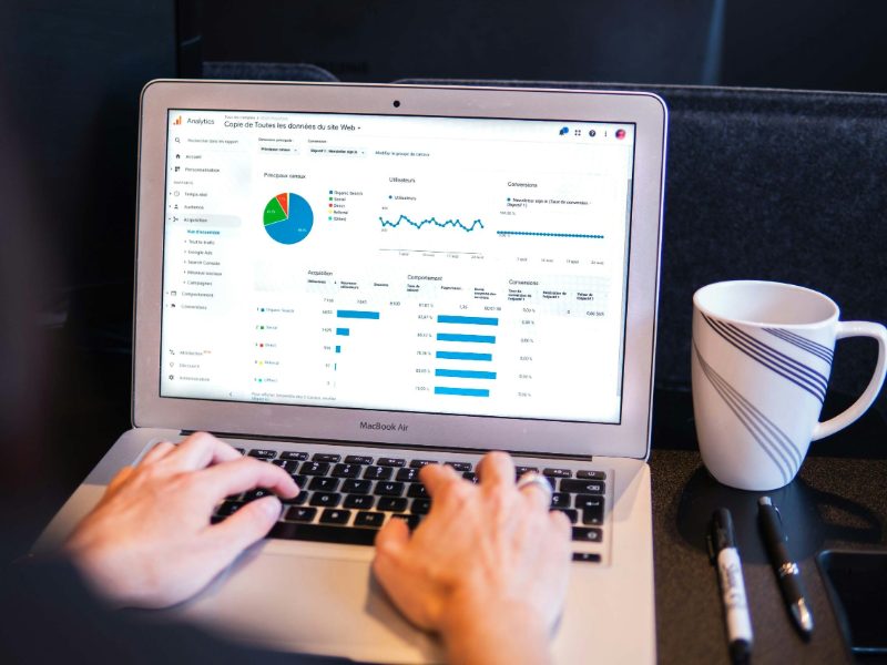 Person working on a laptop showing a results dashboard