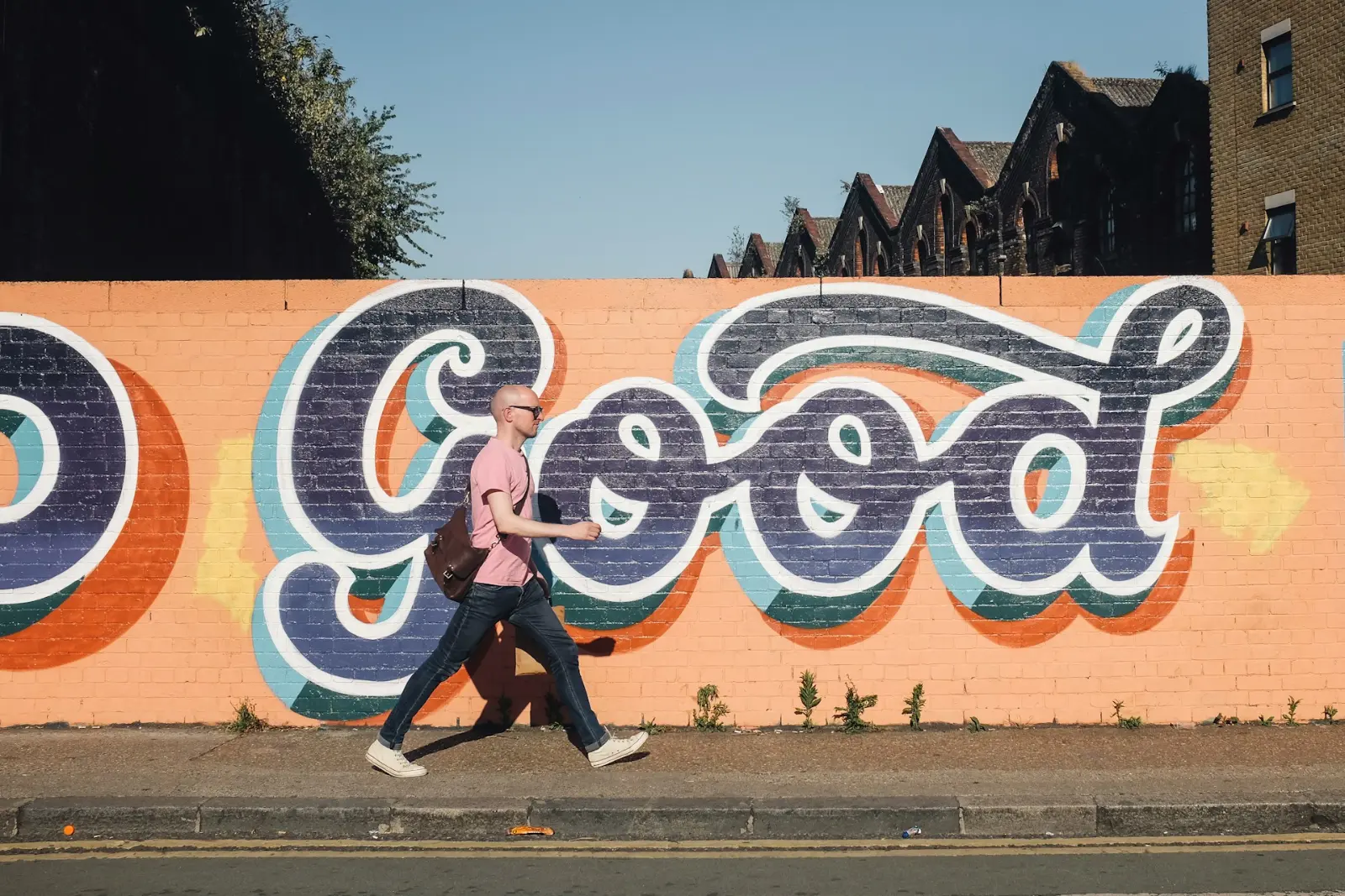 About Mouthy Marketing. Man walking past mural