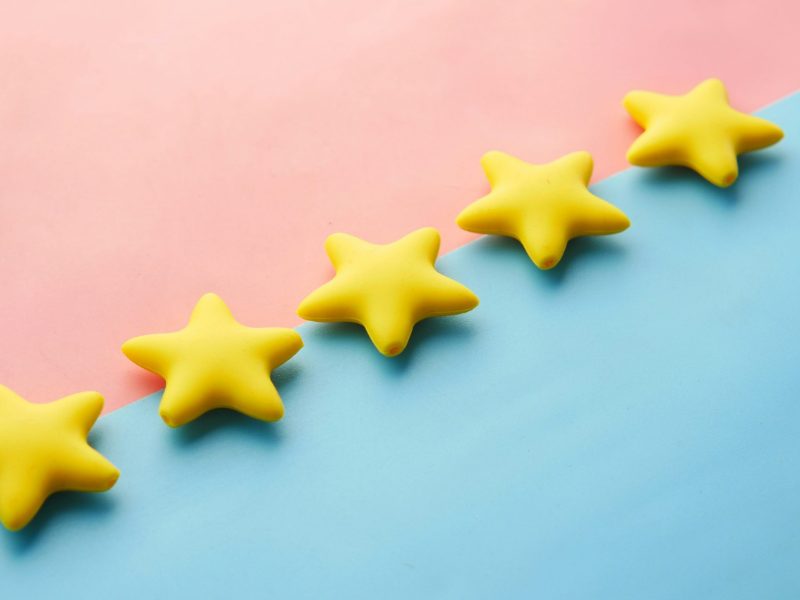 Row of yellow five-star shapes on a pink and blue background