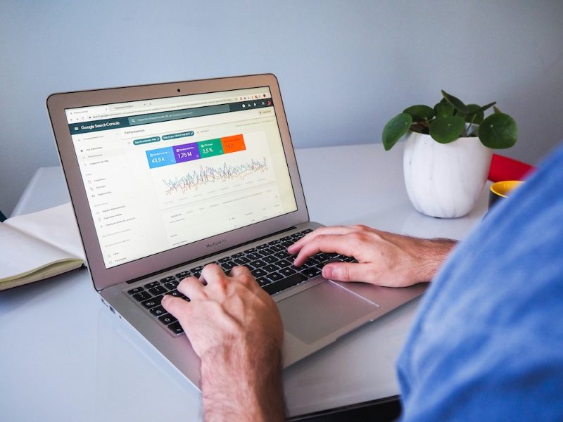 Person using a laptop showing a marketing dashboard
