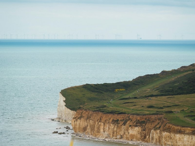 Grassy clifftop above chalk cliffs and the sea