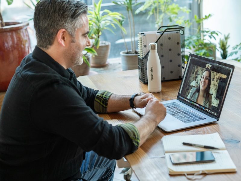 Man on a video call on a laptop at a desk